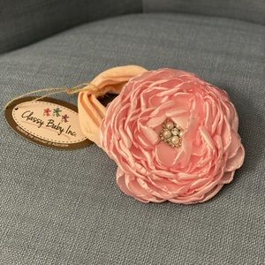 NWT pink flower baby headband with rhinestone in the middle.